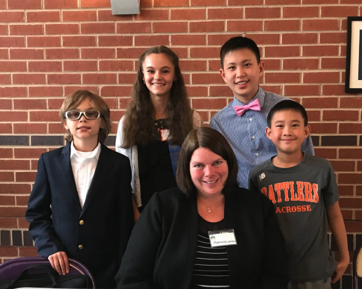 Dr. Albrecht with four students after a music event