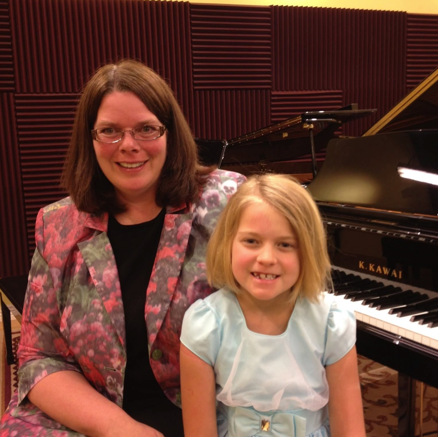 Dr. Martha Albrecht with a young piano student at a Kawai grand piano